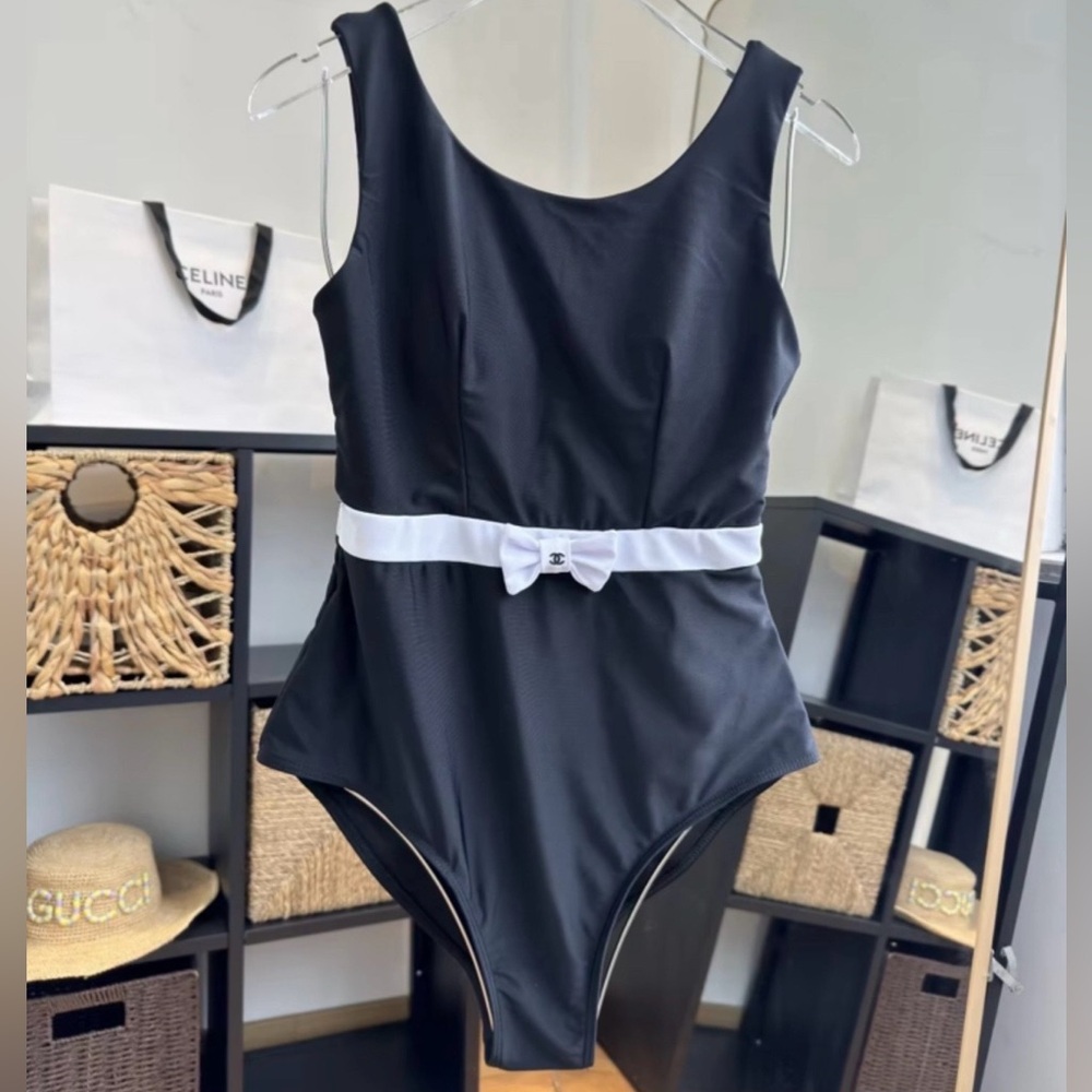 Sleek Black One-Piece Swimsuit with White Bow Belt